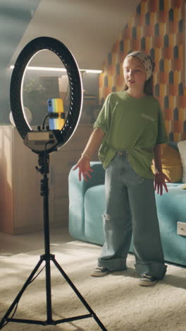 teenager recording a dance video using a ring light