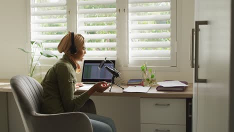 video of biracial woman in hijab taking part in online interview on laptop at home