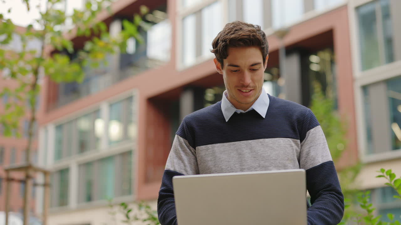 Man using laptop outdoors in city