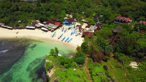 aerial top down shot of tropical beach with parking fisherman boats on sandy beach - central java,indonesia