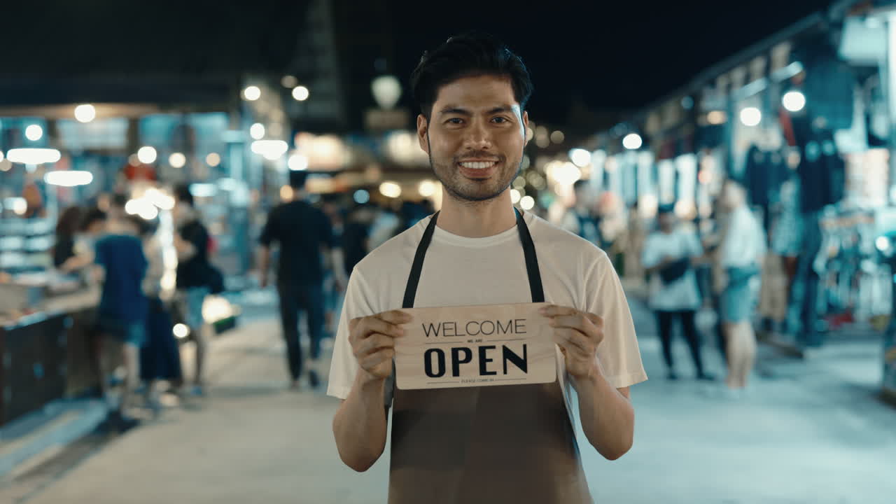 Friendly Business Owner Welcoming Customers at Night Market
