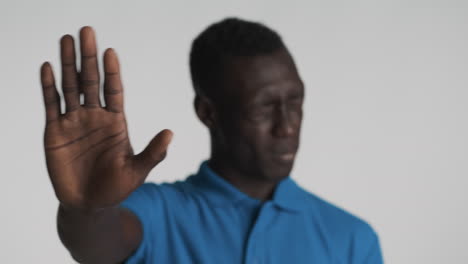 displeased african american man on grey background.