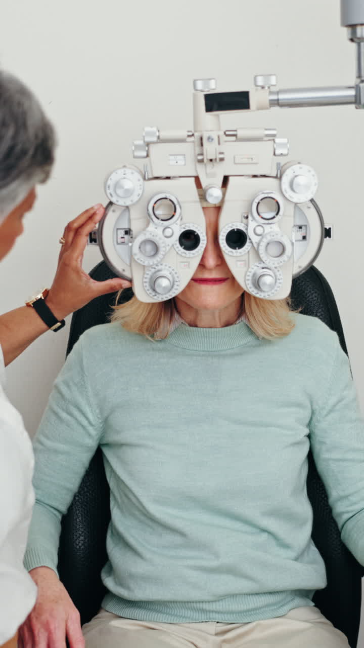 Woman undergoing an eye exam with a phoropter