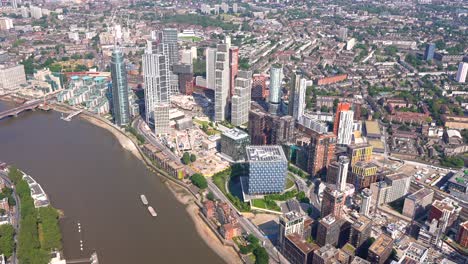 Aerial-view-of-Embassy-Gardens,-Nine-Elms,-Vauxhall-Bridge-and-the-River-Thames