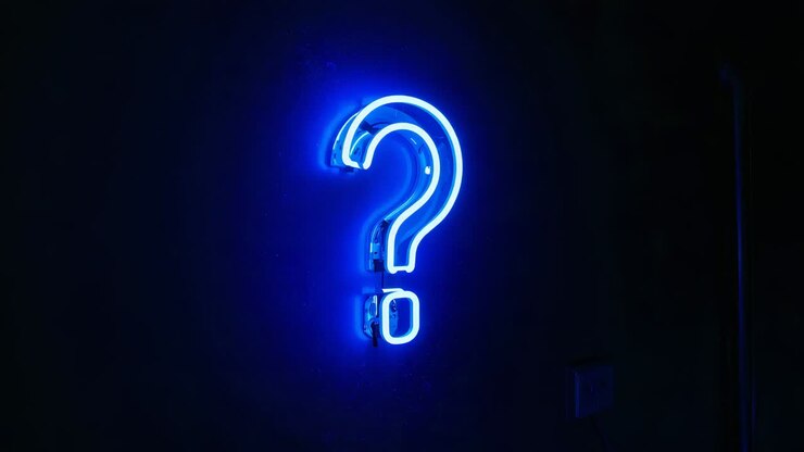 Brightening blue neon question-mark sign pulsing on dark wall with current rising, wall plate seen