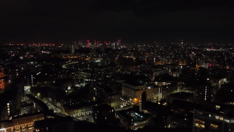 aerial view rising in front of the rotherhithe neighborhood, night in london