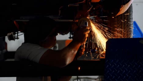 male mechanic using grinder machine 4k