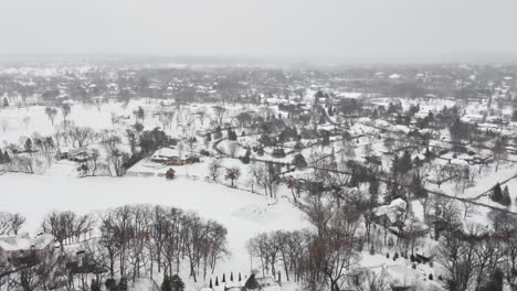 Aerial,-people-skating-on-a-homemade-backyard-ice-rink-during-winter