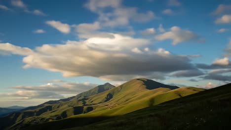 Breathtaking Landscape Transition: Majestic Mountains Shimmering Under a Dynamic Sky with Clouds from Daylight to Dusk in Nature's Splendor