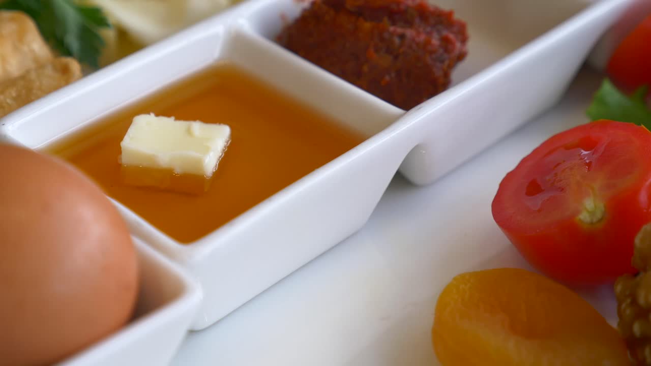 Breakfast Plate with Egg, Honey, and Pastries