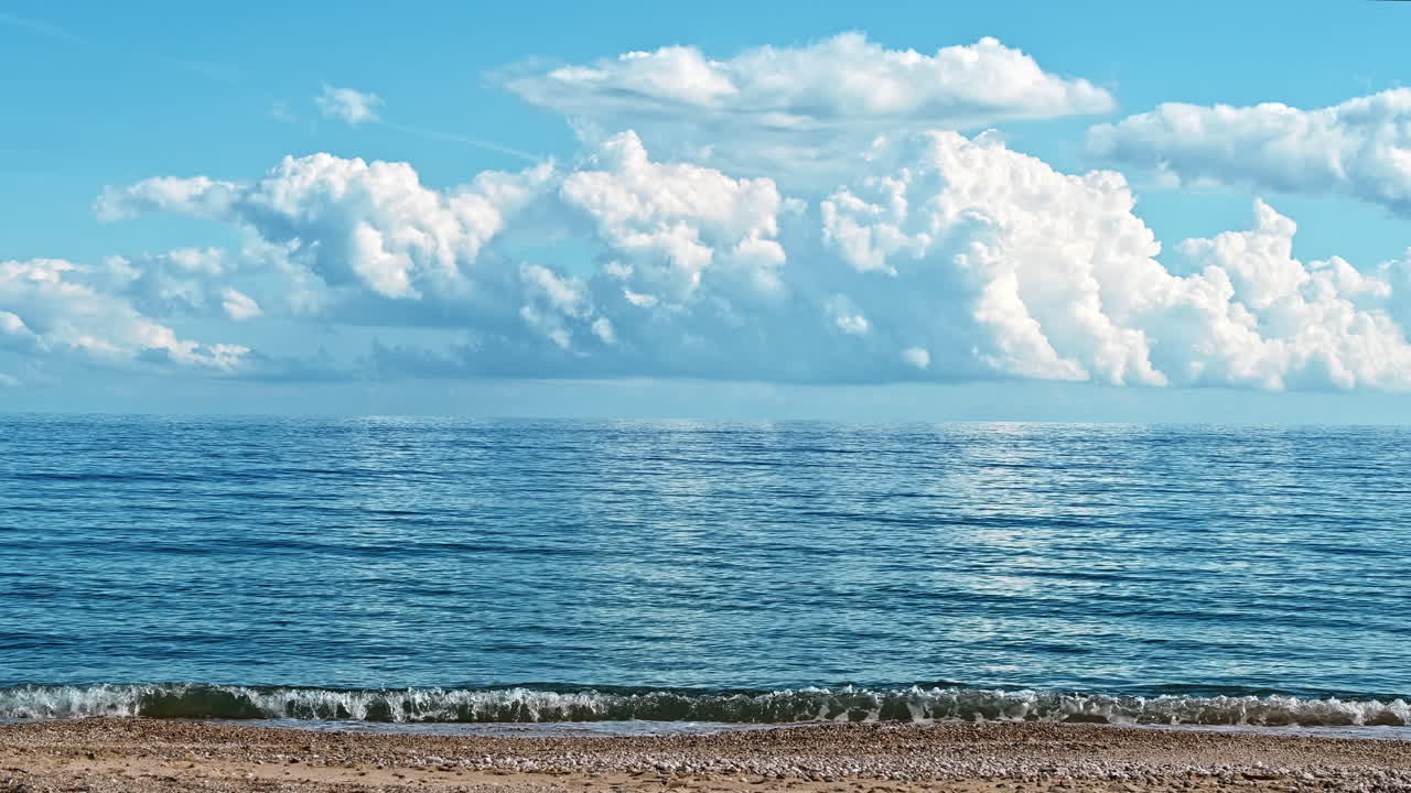 Aegean sea coast in Asprovalta, Greece. Cloudy sky, waves