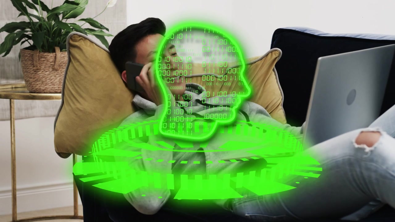 Man reclining typing laptop as green hologram animating on torso, reaching phone, calling for tech