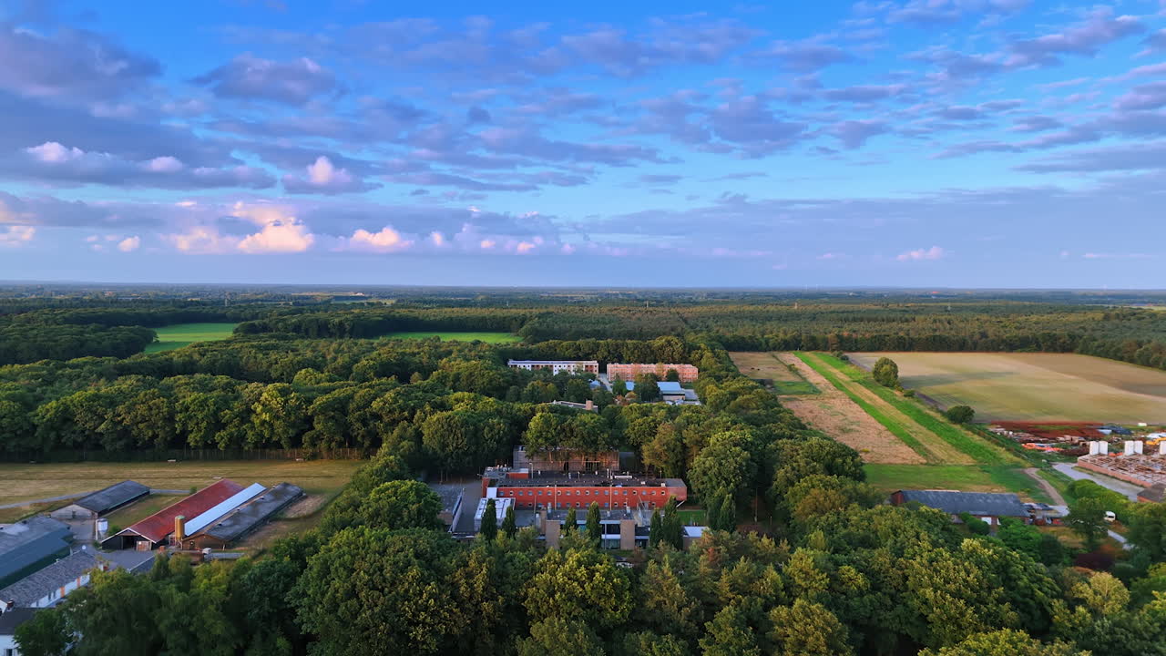 Houses and farms located in the countryside. Drone footage over the forests in the rural area