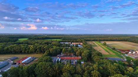 houses and farms located in the countryside. drone footage over the forests in the rural area