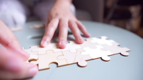 closeup hand of woman connecting jigsaw puzzle, business solutions, success and strategy concept