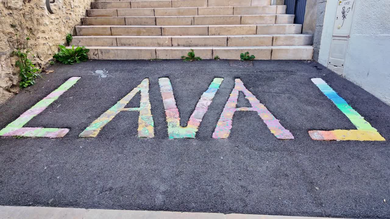 Top down angled view of painted surface near Laval civic area showing abstract pavement markings for town