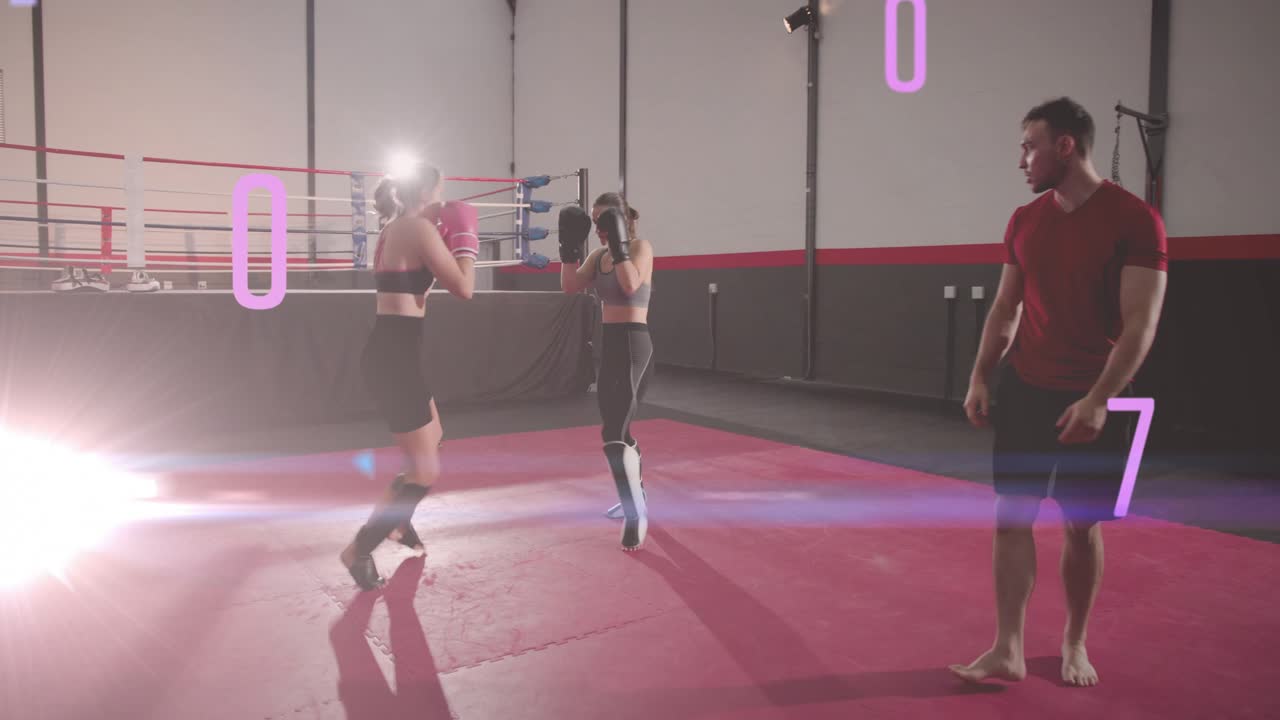 Two women fighters lifting knees trading kicks for drill trainer walking observing numeric overlay
