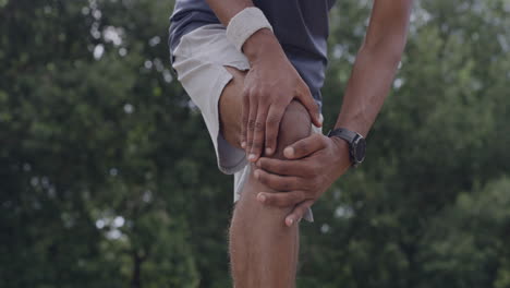 injured man with a sore knee from exercise