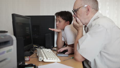 grandfather repairs grandson computer 1