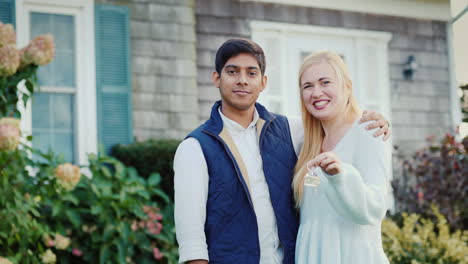 couple show off new house key