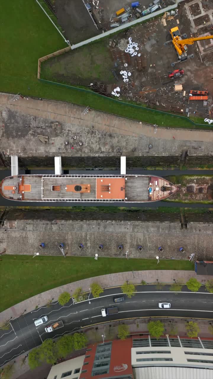 Overhead social ratio aerial video of the SS Nomadic at Titanic Belfast in Northern Ireland, UK. Produced in 1080x1920, 60FPS and with Rec709 color