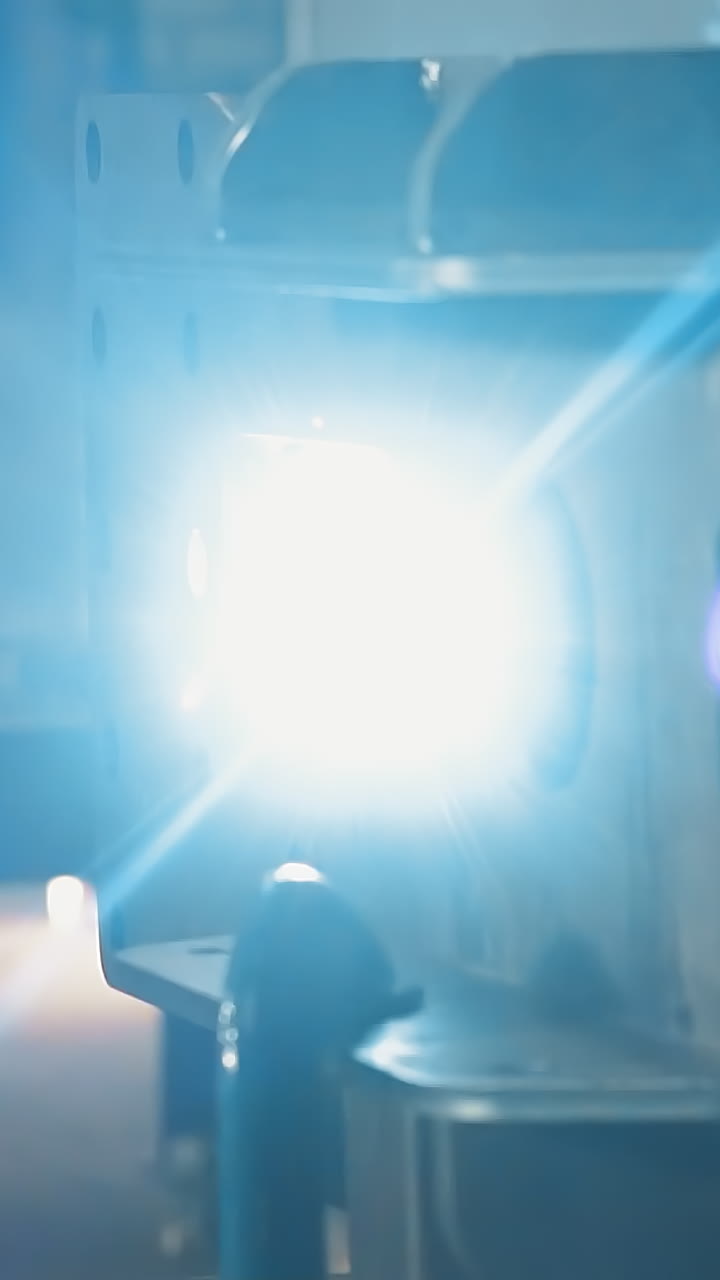 Welding of metal construction with flame and sparks in production plant workshop closeup. Technology of metalworking and assembling complicated construction