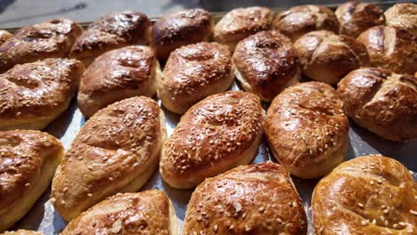 close-up of freshly baked golden brown pastries with sesame seeds