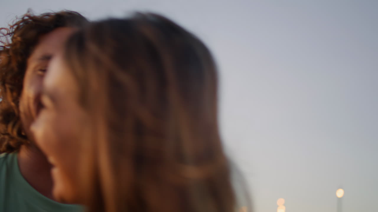 Couple Enjoying a Sunset Walk on the Pier