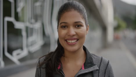 portrait of young woman commuter smiling happy looking at camera enjoying successful lifestyle in urban city street