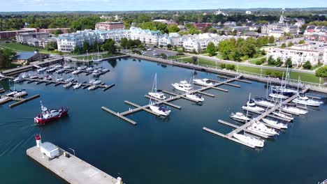 coast guard search and rescue boat sailing into marina with boats moored at docks