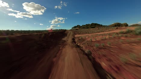 drone flying low over a road with fpv drone