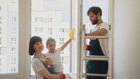 family cleaning windows together