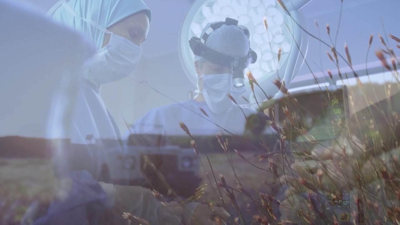 Two surgeons leaning, starting surgery, adjusting tools while meadow overlay drifting over team