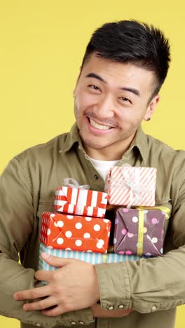 man holding stack of gifts