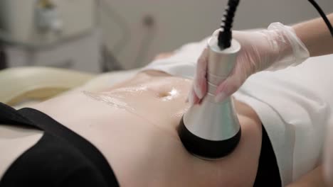 body rf lifting procedure. woman getting anti-cellulite and anti-fat therapy