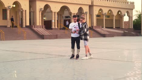 happy couple of tourists taking selfies outdoors