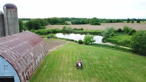 aerial drone shot of tractor in a farm