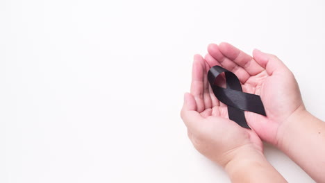 Black-awareness-ribbon-on-gray-background