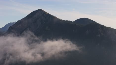 clouds of mist moving gently across the bavarian alps