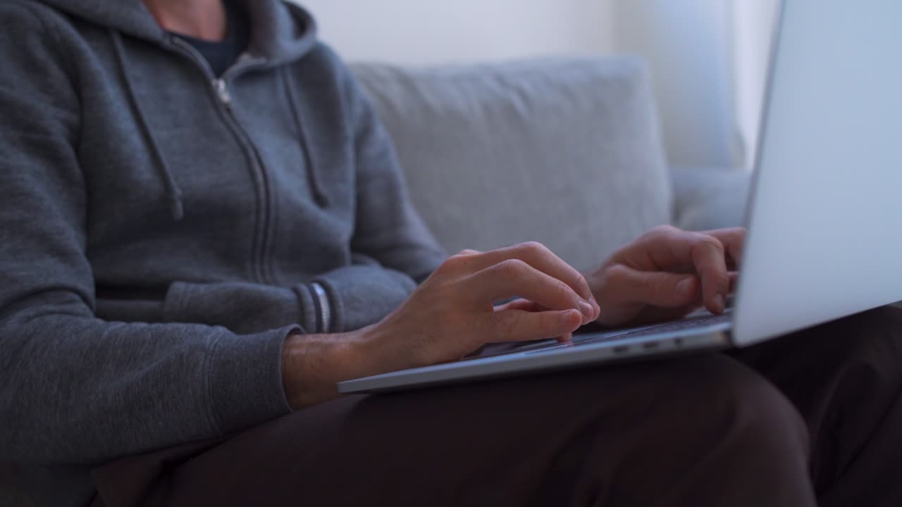 Close up of hands typing on computer while working from home
