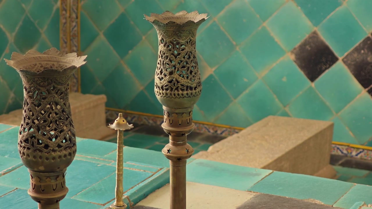 Ornate Antique Metal Candle Holders in Traditional Persian Interior