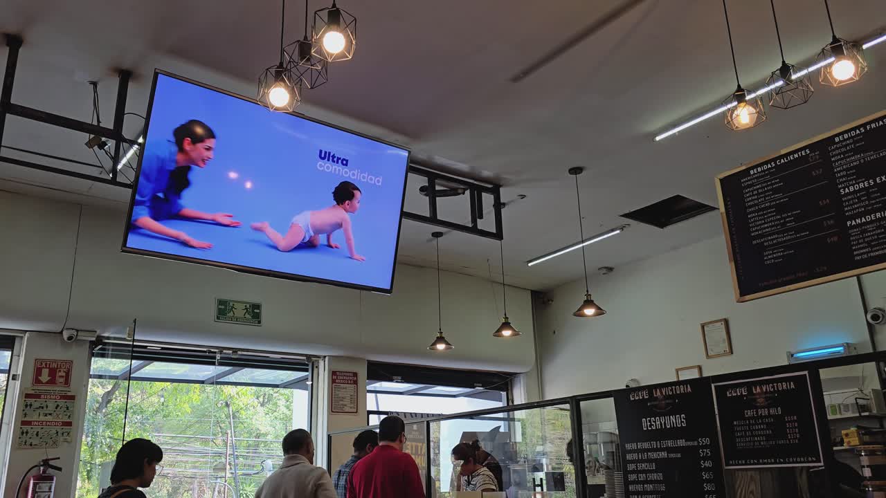 Traditional coffee shop featuring a ceiling-mounted smart TV