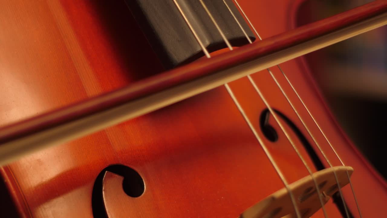 Close-up of a Musician's Hand Playing Cello with a Bow