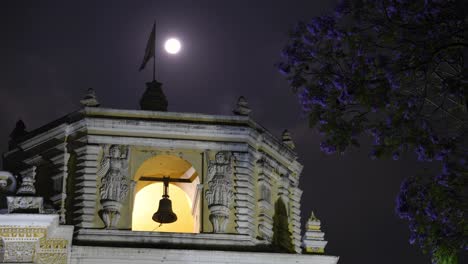 Timelapse-captures-the-moon’s-journey-across-the-night-sky,-perfectly-framed-by-La-Merced-Church’s-iconic-bell-tower