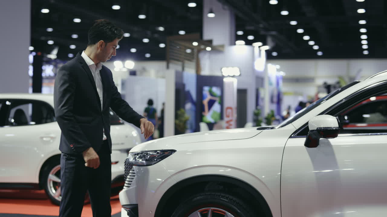 Businessman Examining a White SUV at an Auto Show