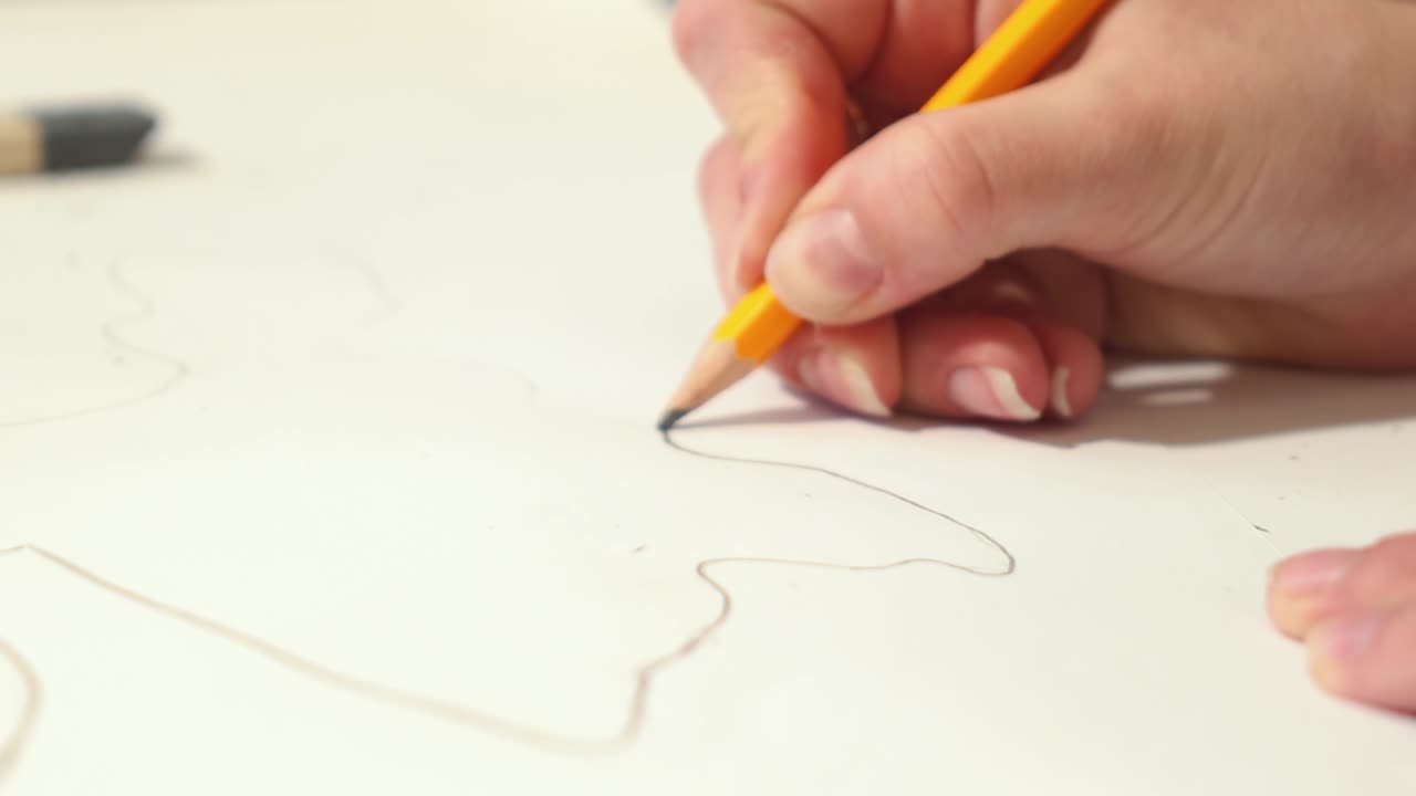 Woman is drawing with pencil sketch. Artist is working on a project.