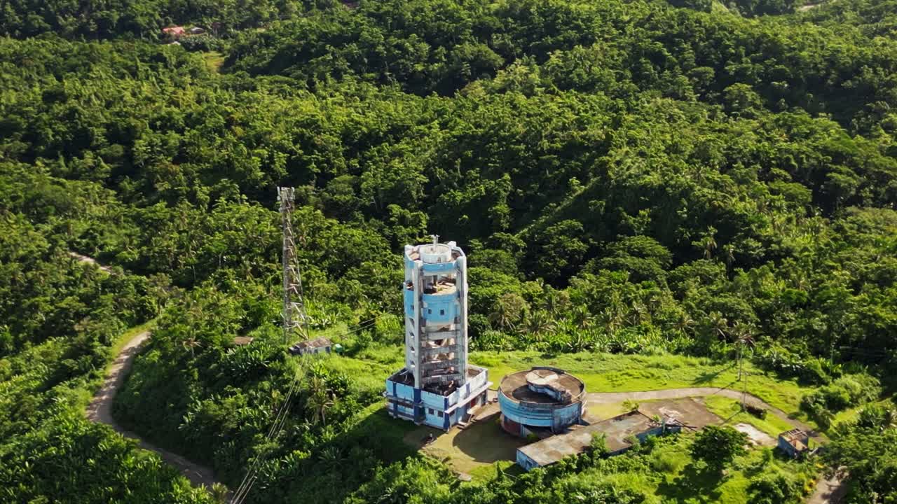 PAGASA weather radar station on a lush hilltop amid tropical island greenery at Buenavista, Catanduanes, Philippines - aerial drone shot