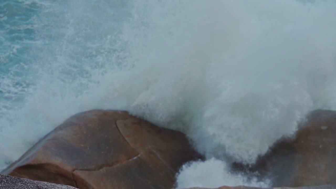 Powerful Ocean Waves Crashing Against Large Coastal Rocks