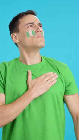 Man listening to the Nigeria national anthem with solemnity