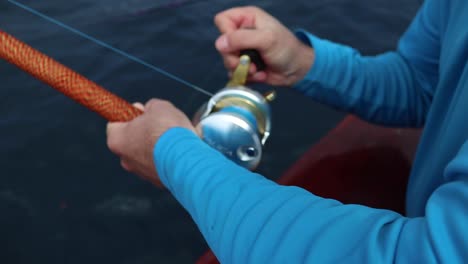 winding a conventional fishing reel in slow motion